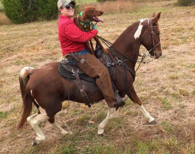 Kelli Aitken on horseback with Irish Setter